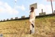 A naked woman sitting on top of a cement block.