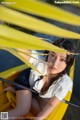 A woman sitting in a yellow boat on the water.