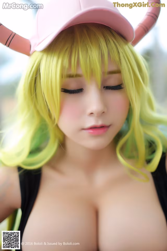 A woman with green hair wearing a pink hat.