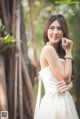 A woman in a wedding dress posing for a picture.