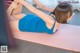 A woman in a blue dress is doing a yoga pose.