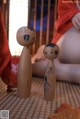 A couple of wooden dolls sitting on top of a table.