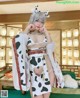 A woman in a cow costume posing for a picture.