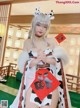 A woman dressed in a cow costume posing for a picture.